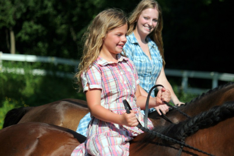 Two girls and two horses
