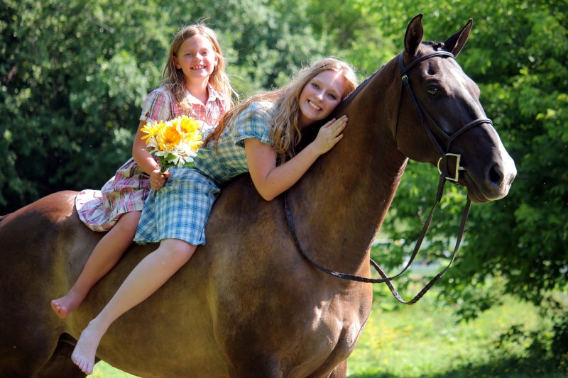 Two girls and two horses